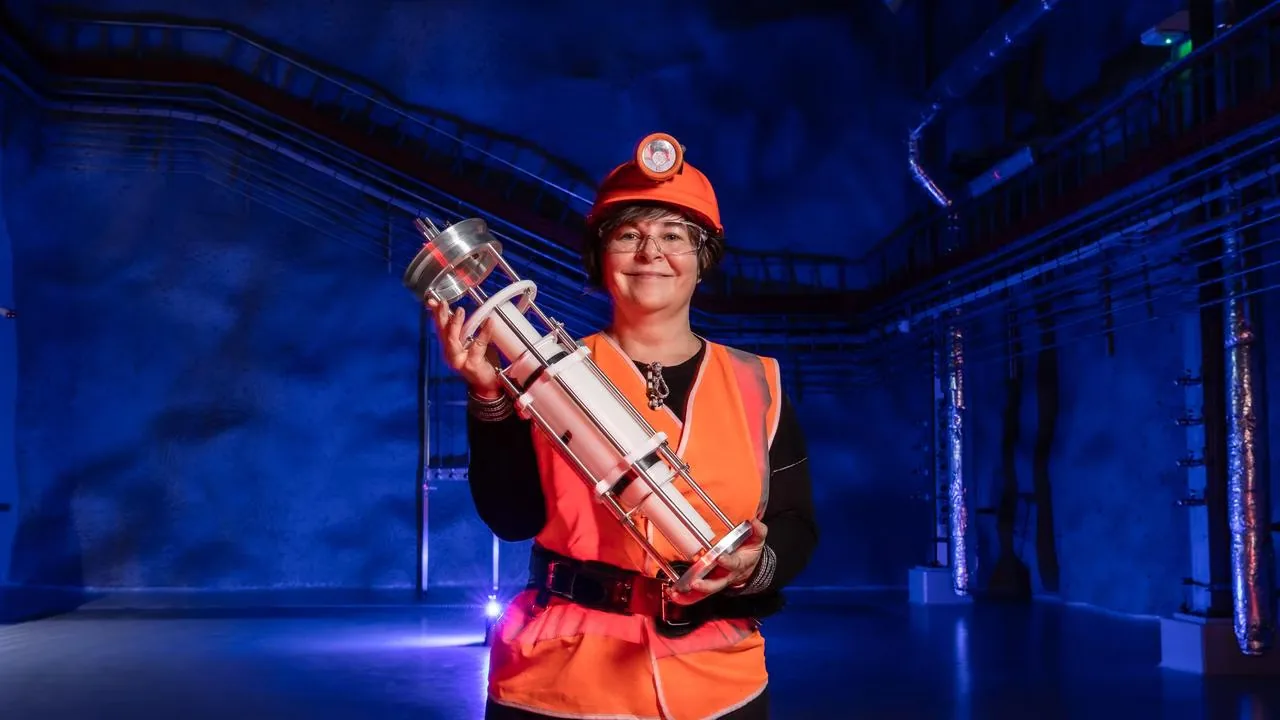 Professor Elisabetta Barberio holding a SABRE crystal detector module